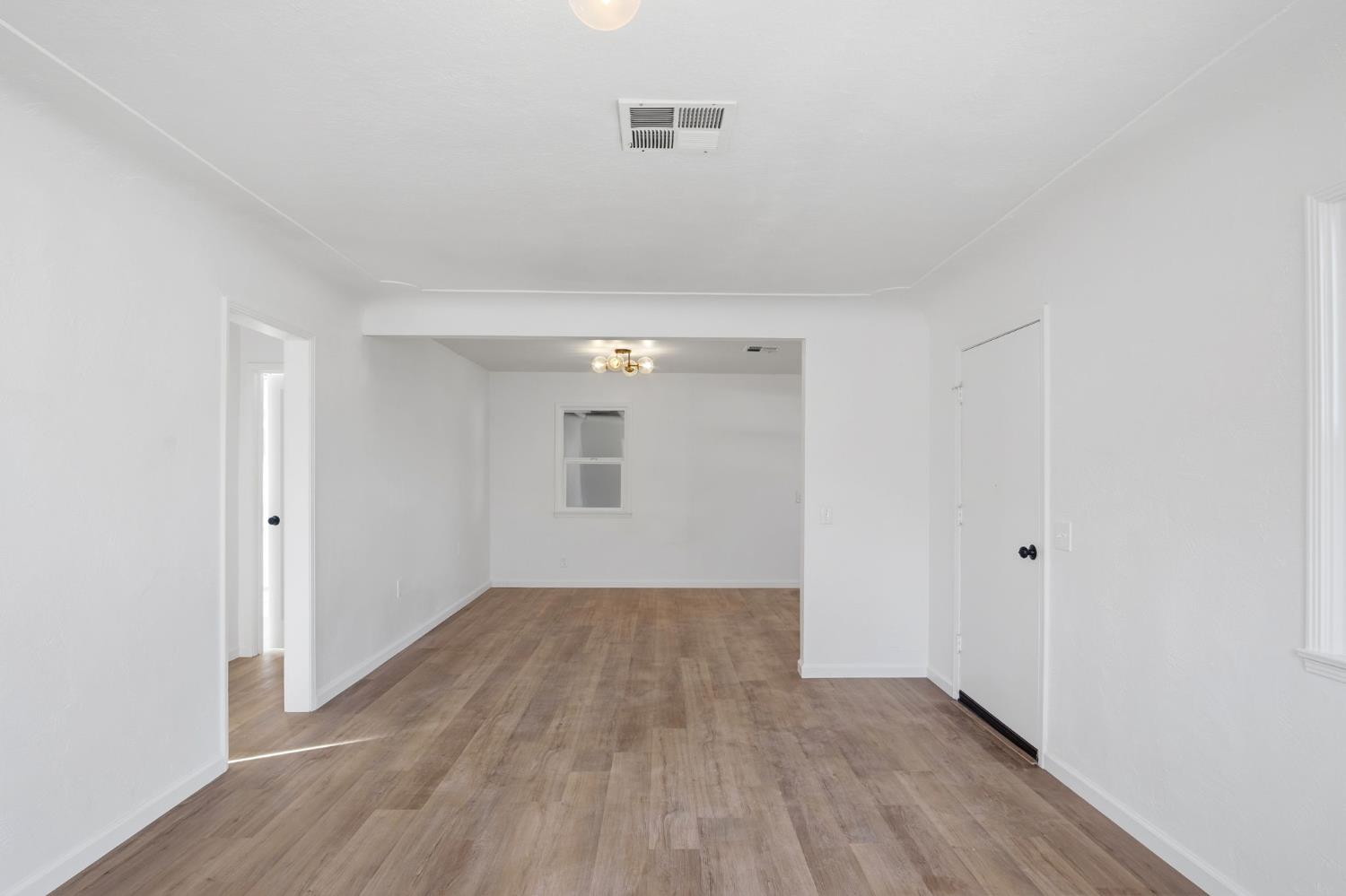 816 Dawn Drive Modesto, CA 95350 - Photo 8 of 22 a view of an empty room with wooden floor