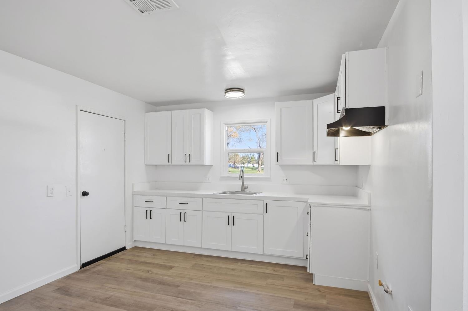 816 Dawn Drive Modesto, CA 95350 - Photo 9 of 22 a kitchen with a sink cabinets and wooden floor