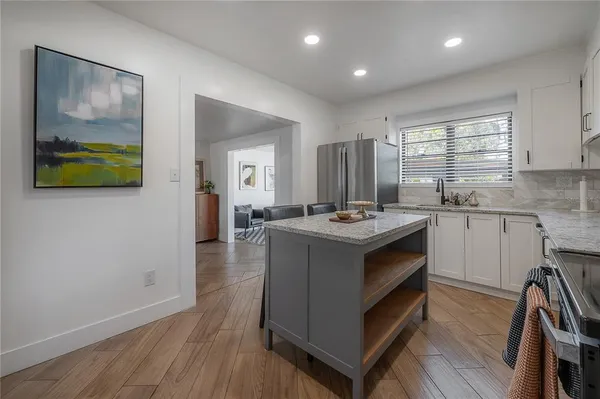 a living room with granite countertop furniture and wooden floor