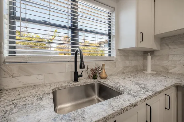 a kitchen with stainless steel appliances granite countertop a stove and a refrigerator