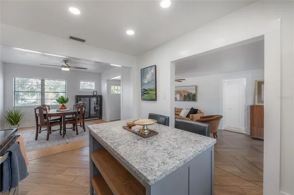 a dining room with furniture a rug and a chandelier