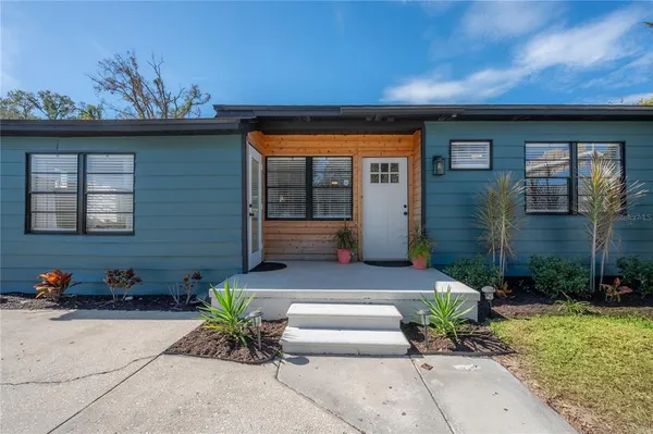 a view of a porch with furniture and garden