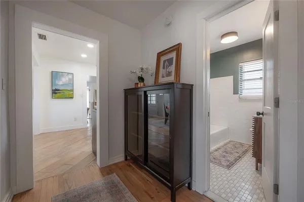 a spacious bedroom with a bed and a window