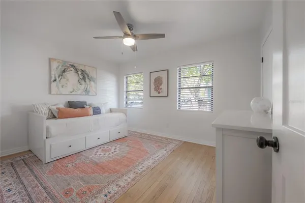 a view of a hallway with painting on the wall