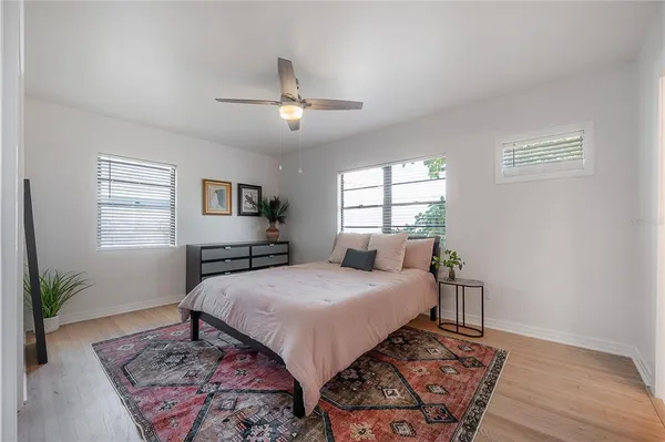 a kitchen with stainless steel appliances kitchen island granite countertop a refrigerator a stove a microwave oven a sink with wooden floor and cabinets