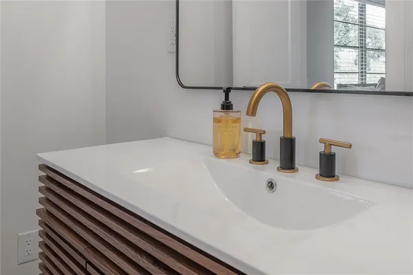 a bedroom with a large bed and a chandelier fan