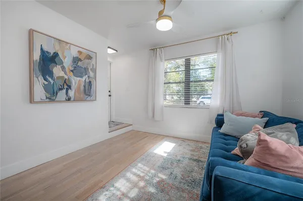 a view of a porch with furniture and a backyard