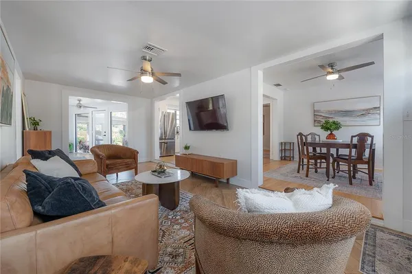 a view of a dining room with furniture and a chandelier