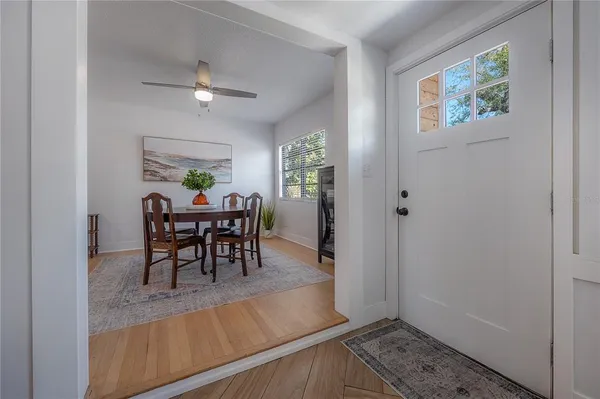 a living room with furniture a rug and a painting on the wall