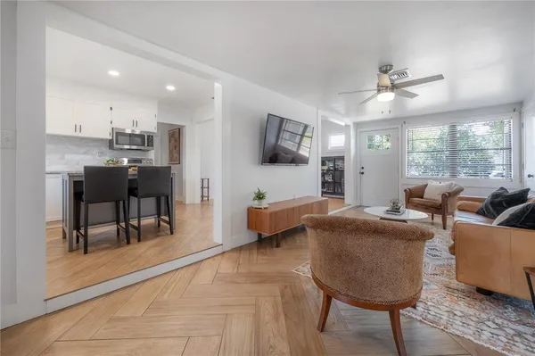 a view of kitchen with granite countertop cabinets and entryway