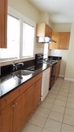 a kitchen with stainless steel appliances a sink stove and window