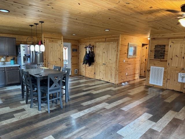 535 Big Springs Road Medon, TN 38356 - Photo 5 of 15 Dining space featuring dark wood-type flooring, wood ceiling, wood walls, and a ceiling fan