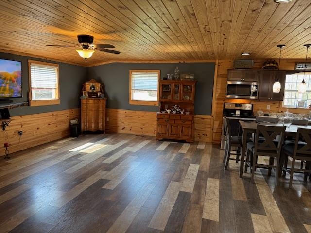 535 Big Springs Road Medon, TN 38356 - Photo 6 of 15 Dining space with wood walls, dark wood finished floors, wainscoting, ceiling fan, and wood ceiling