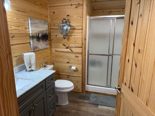 535 Big Springs Road Medon, TN 38356 - Photo 9 of 15 Full bathroom featuring a stall shower, wood walls, vanity, and dark wood-style floors