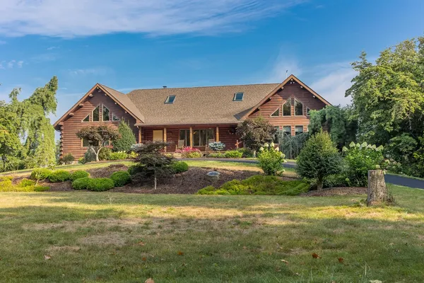 a front view of a house with a garden