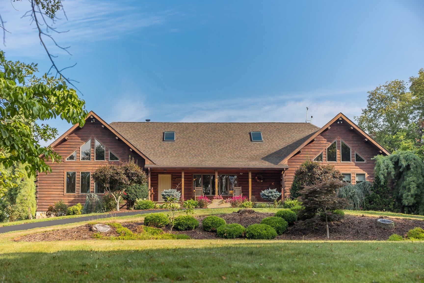 1003 Natural Chimney Road Mount Solon, VA 22843 - Photo 2 of 73 a front view of a house with a yard and potted plants
