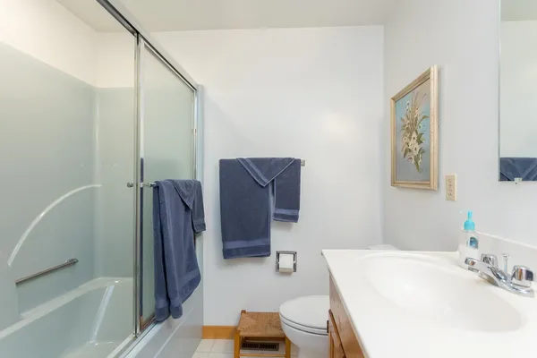 a kitchen with granite countertop white cabinets stainless steel appliances a sink and a window