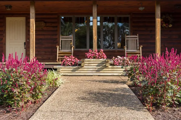 a view of a patio with lawn chairs floor to ceiling window with wooden floor