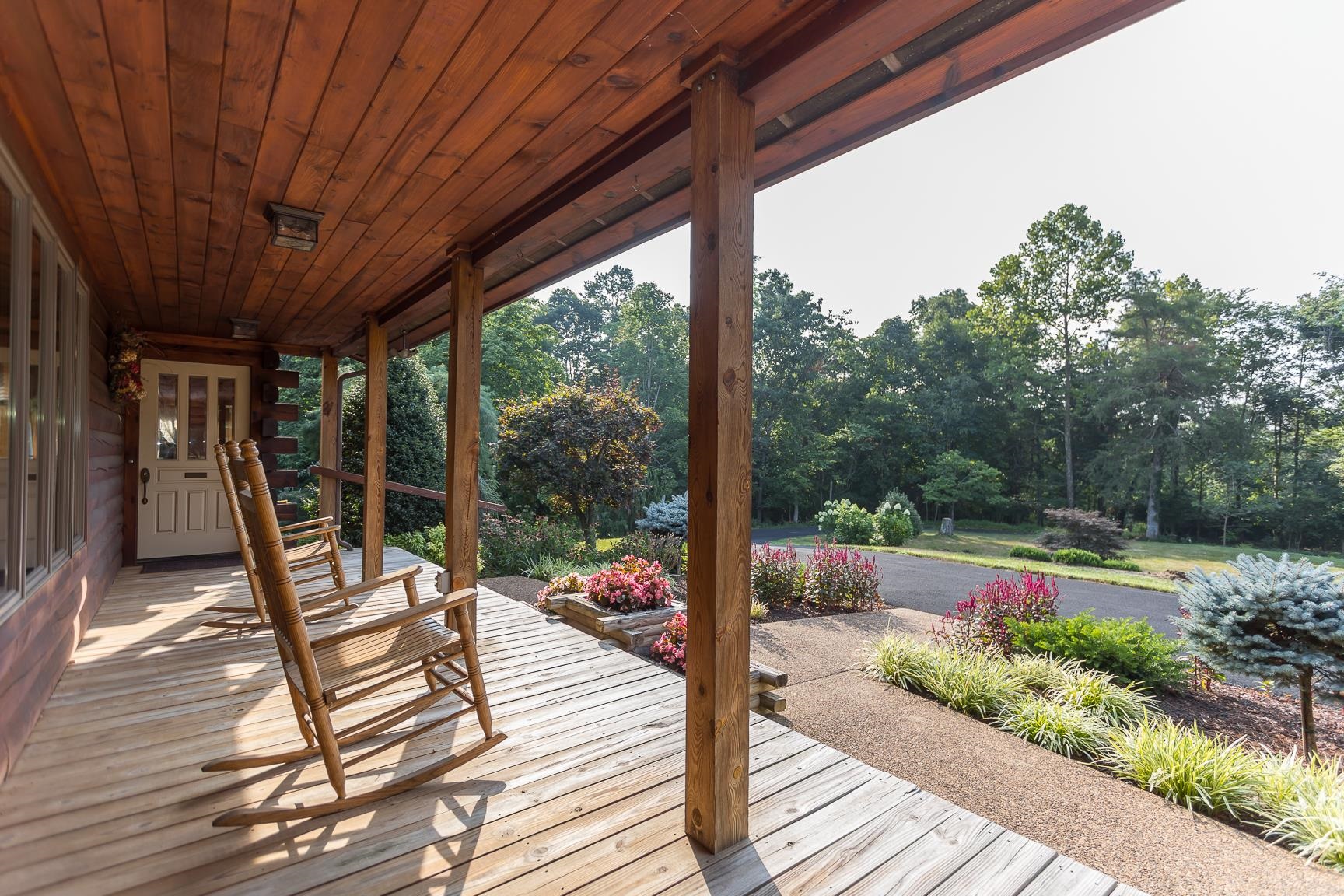 1003 Natural Chimney Road Mount Solon, VA 22843 - Photo 7 of 73 a view of a patio with lawn chairs floor to ceiling window with wooden floor