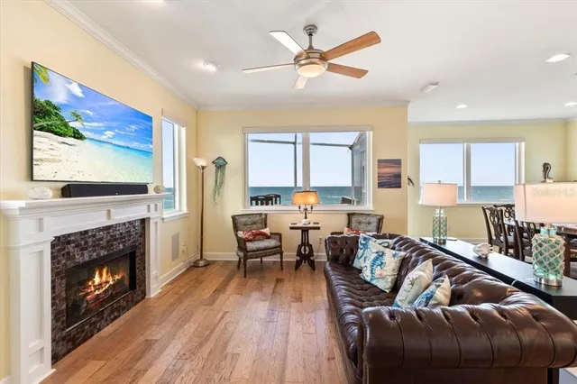 a view of a a dining room with furniture window and wooden floor
