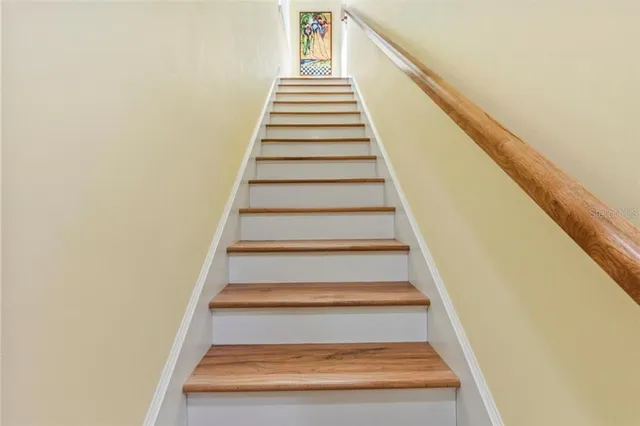 a bedroom with a bed and a dresser next to a window
