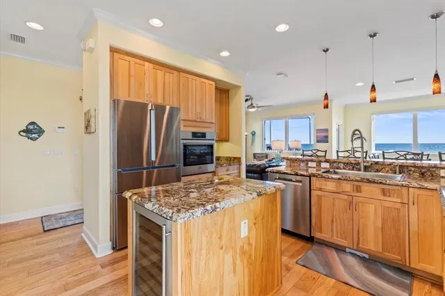 a large kitchen with lots of counter top space and stainless steel appliances