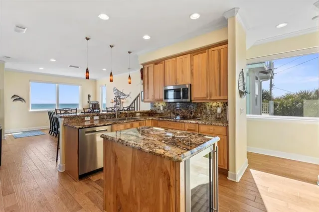 a kitchen with stainless steel appliances granite countertop a sink and cabinets