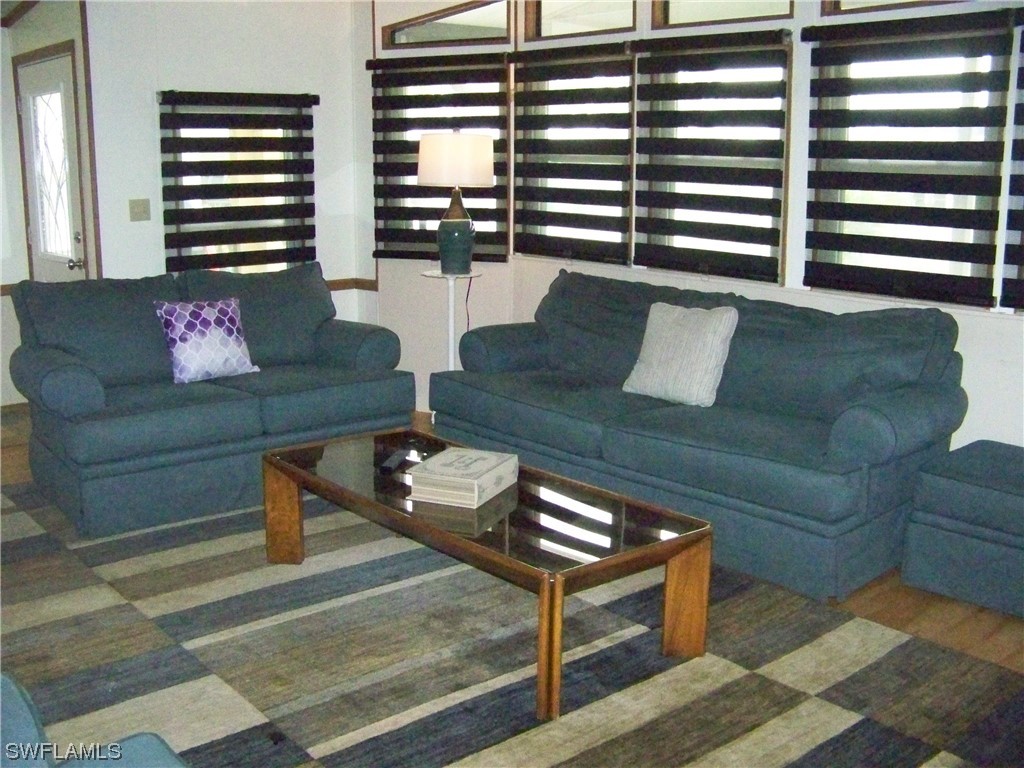 15550 Burnt Store Road, Unit 51 Punta Gorda, FL 33955 - Photo 12 of 50 a living room with furniture and a large window