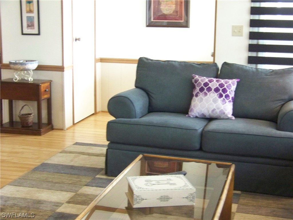15550 Burnt Store Road, Unit 51 Punta Gorda, FL 33955 - Photo 13 of 50 a living room with furniture and a fireplace