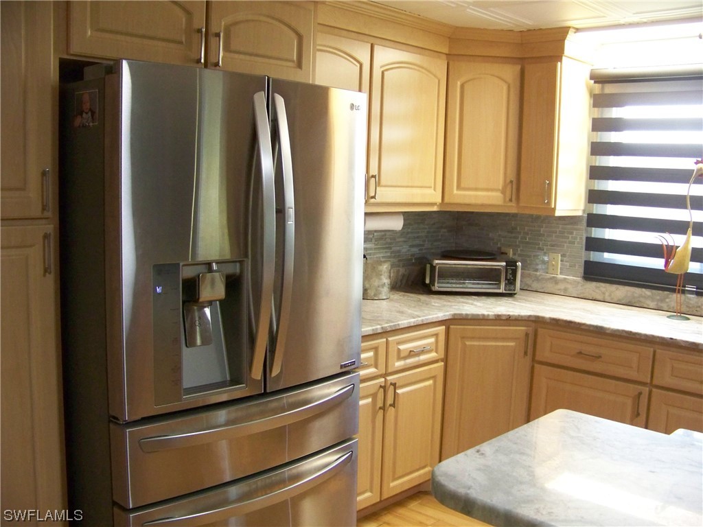 15550 Burnt Store Road, Unit 51 Punta Gorda, FL 33955 - Photo 17 of 50 a kitchen with stainless steel appliances granite countertop a refrigerator and a sink