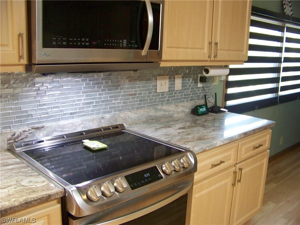 15550 Burnt Store Road, Unit 51 Punta Gorda, FL 33955 - Photo 20 of 50 a kitchen with a stove and a microwave