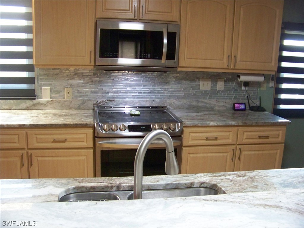 15550 Burnt Store Road, Unit 51 Punta Gorda, FL 33955 - Photo 21 of 50 a kitchen with a sink and cabinets