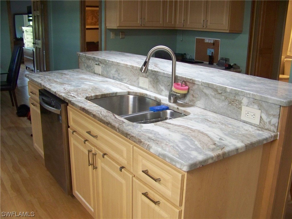 15550 Burnt Store Road, Unit 51 Punta Gorda, FL 33955 - Photo 22 of 50 a kitchen with stainless steel appliances granite countertop a sink dishwasher and cabinets