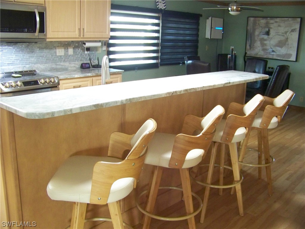 15550 Burnt Store Road, Unit 51 Punta Gorda, FL 33955 - Photo 23 of 50 a kitchen with a sink and cabinets