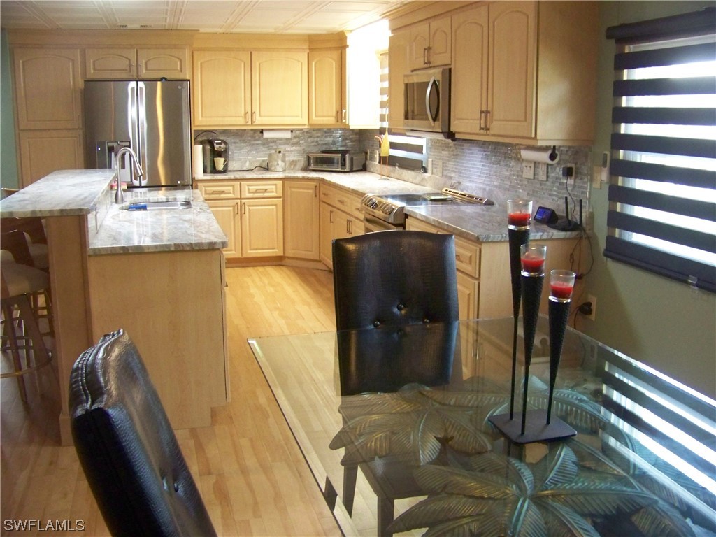 15550 Burnt Store Road, Unit 51 Punta Gorda, FL 33955 - Photo 24 of 50 a kitchen with sink refrigerator and window