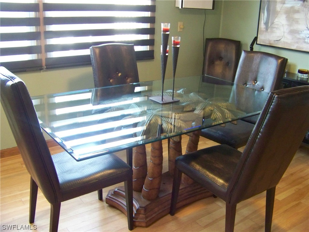 15550 Burnt Store Road, Unit 51 Punta Gorda, FL 33955 - Photo 25 of 50 a view of a dining room with furniture wooden floor and windows