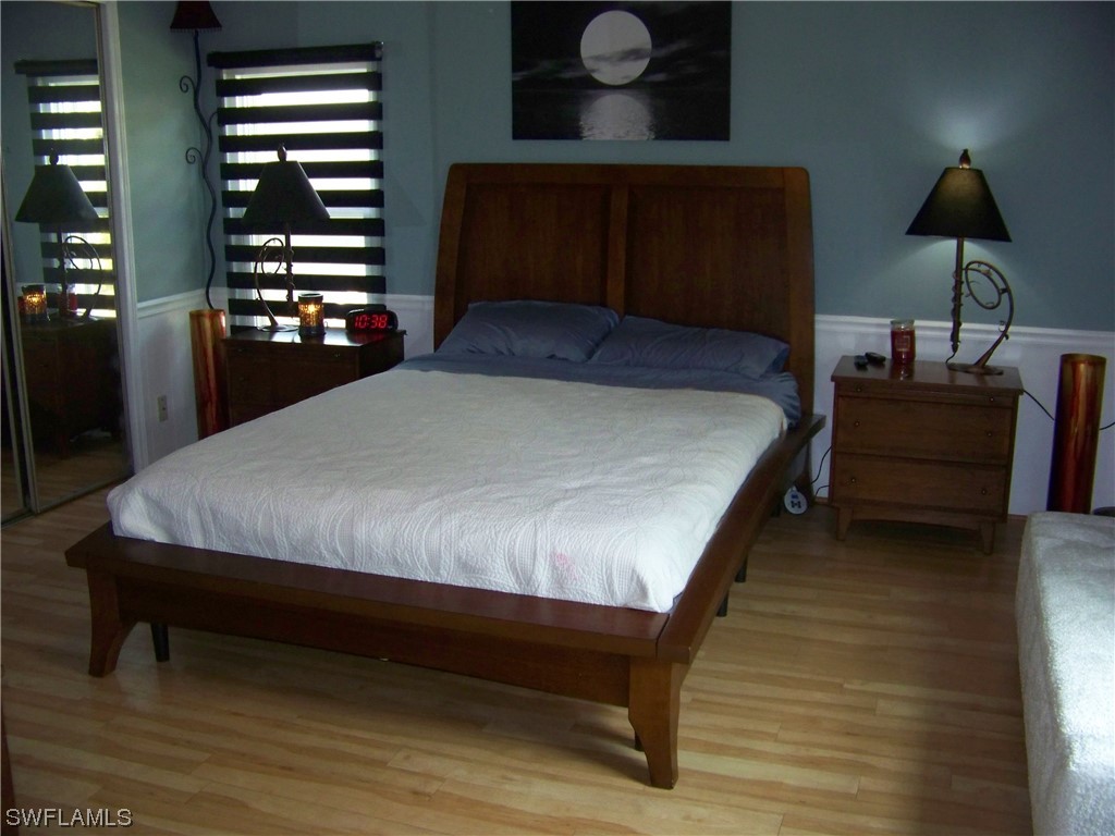15550 Burnt Store Road, Unit 51 Punta Gorda, FL 33955 - Photo 26 of 50 a bedroom with a bed lamp and a dresser