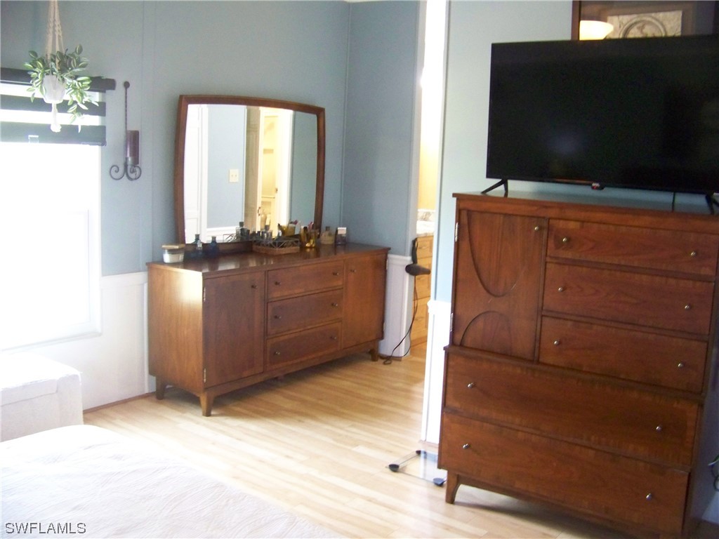 15550 Burnt Store Road, Unit 51 Punta Gorda, FL 33955 - Photo 28 of 50 a living room with furniture and flat screen tv