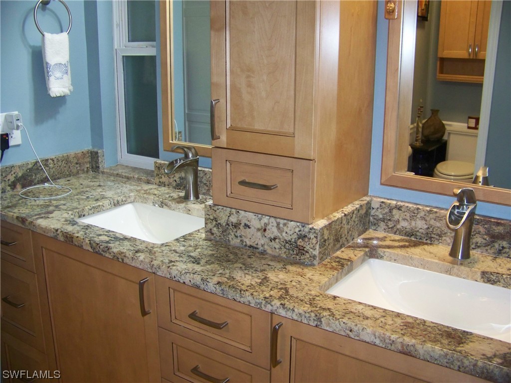 15550 Burnt Store Road, Unit 51 Punta Gorda, FL 33955 - Photo 30 of 50 a bathroom with a granite countertop sink and a mirror