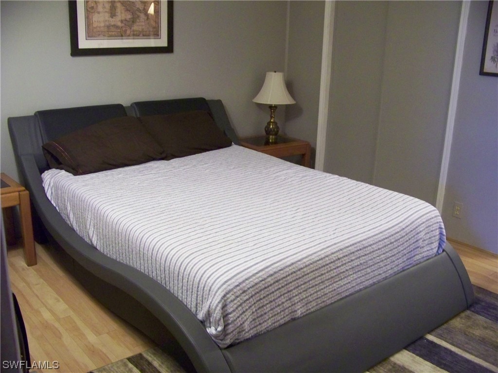 15550 Burnt Store Road, Unit 51 Punta Gorda, FL 33955 - Photo 33 of 50 a bedroom with a bed and a lamp on dresser