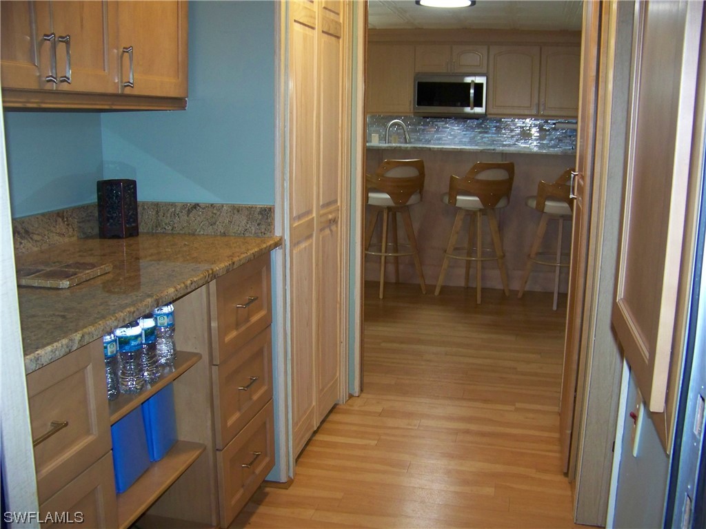 15550 Burnt Store Road, Unit 51 Punta Gorda, FL 33955 - Photo 40 of 50 a bathroom with a granite countertop sink a vanity and a mirror
