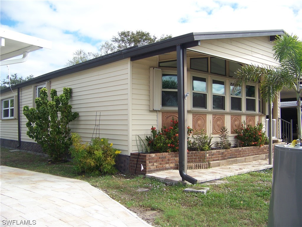 15550 Burnt Store Road, Unit 51 Punta Gorda, FL 33955 - Photo 4 of 50 a front view of a house with a yard