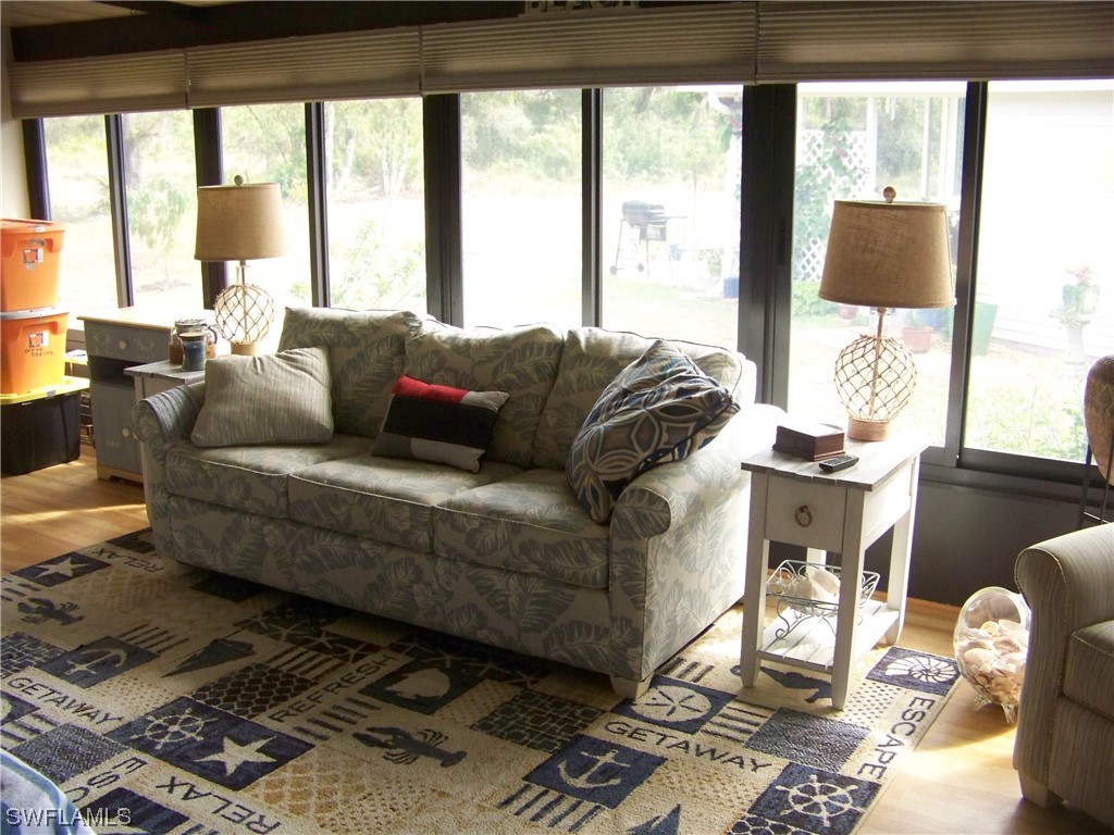 15550 Burnt Store Road, Unit 51 Punta Gorda, FL 33955 - Photo 42 of 50 a living room with furniture and a large window