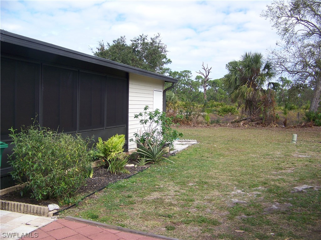 15550 Burnt Store Road, Unit 51 Punta Gorda, FL 33955 - Photo 5 of 50 a view of a backyard with potted plants and large tree