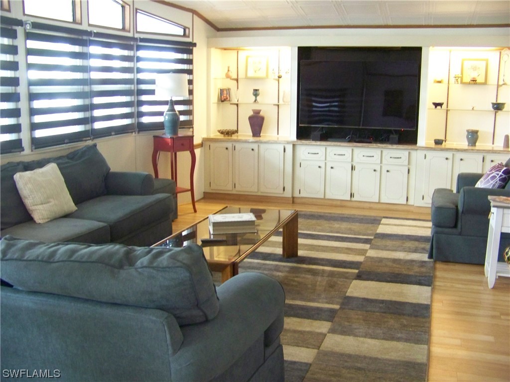 15550 Burnt Store Road, Unit 51 Punta Gorda, FL 33955 - Photo 10 of 50 a living room with furniture cabinets and a flat screen tv
