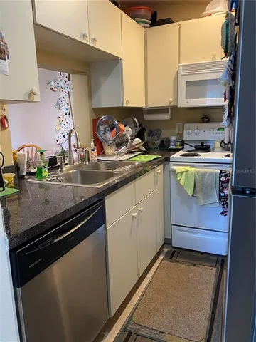 a kitchen with a sink and cabinets