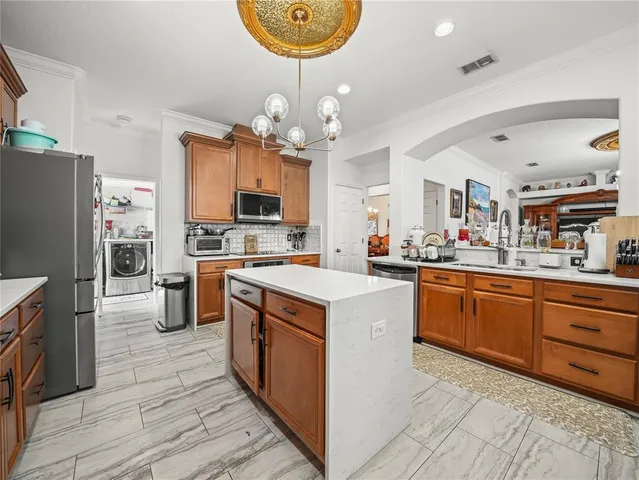 a kitchen with a stove and wooden floor