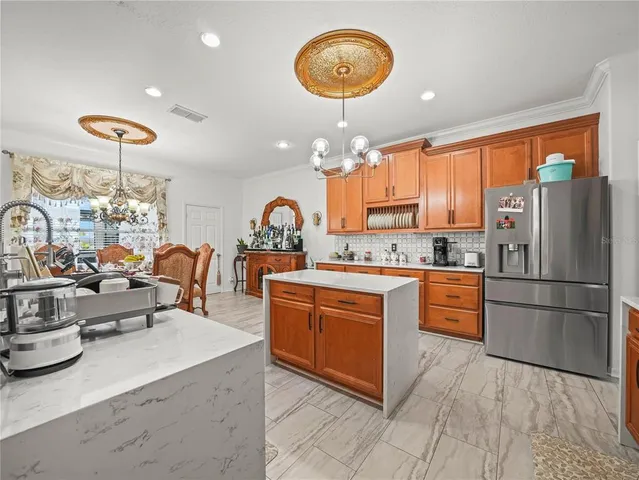 a living room with furniture chandelier and a large window