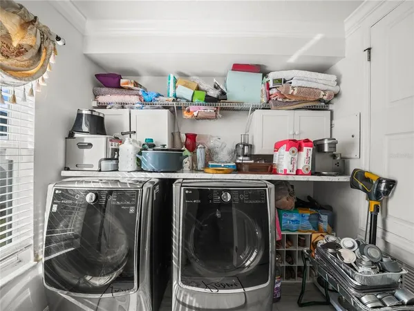 a room with stainless steel appliances kitchen island granite countertop furniture and a rug