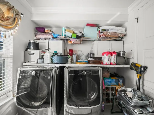 a room with stainless steel appliances kitchen island granite countertop furniture and a rug